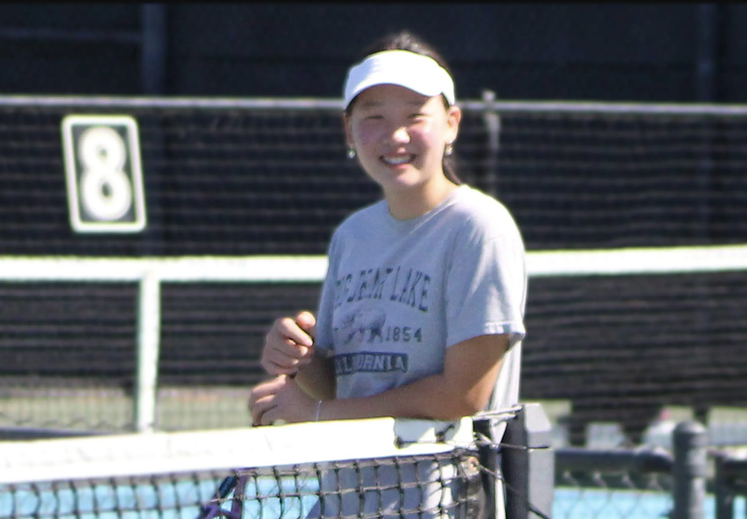 Junior tennis player smiling during Anaheim Tennis Center Summer Camp