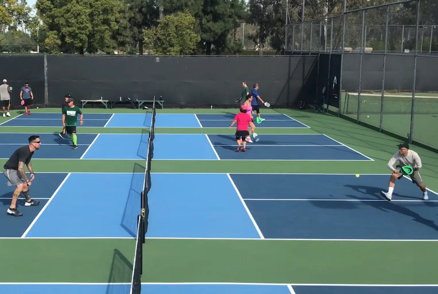 People playing pickleball on outdoor courts