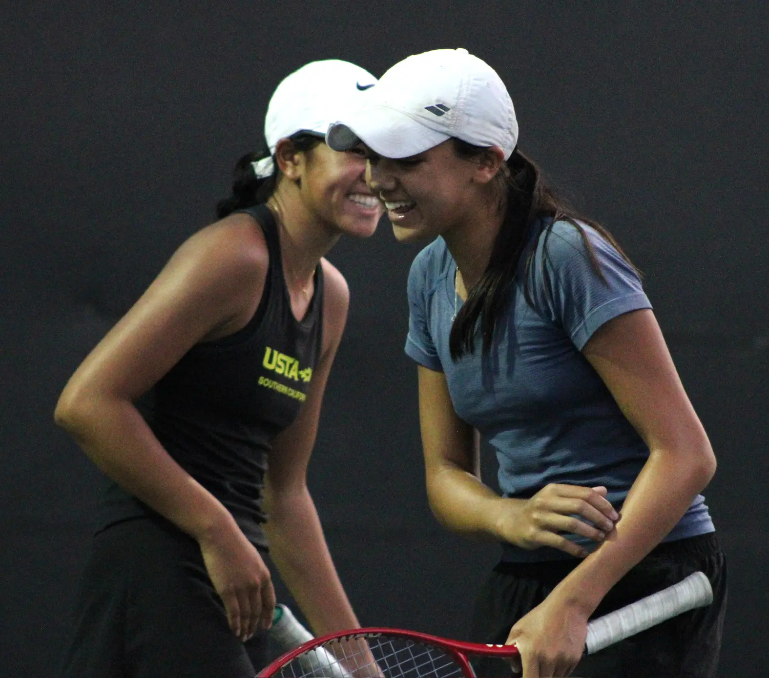 Junior tennis players smiling together