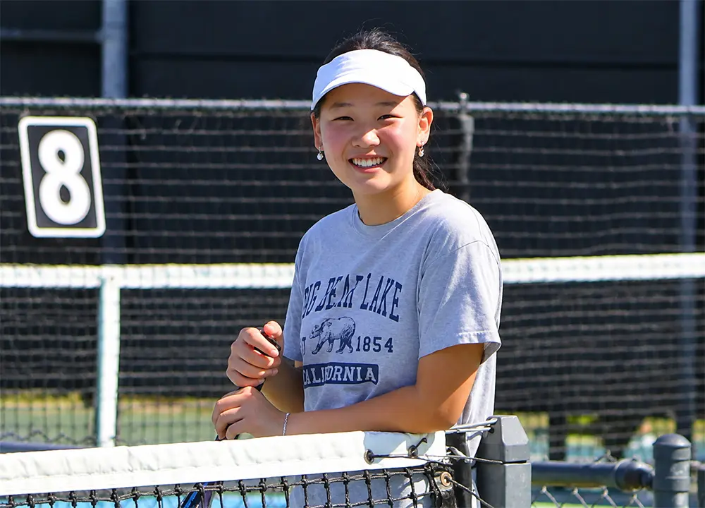 Junior tennis player smiling during Anaheim Tennis Center Summer Camp