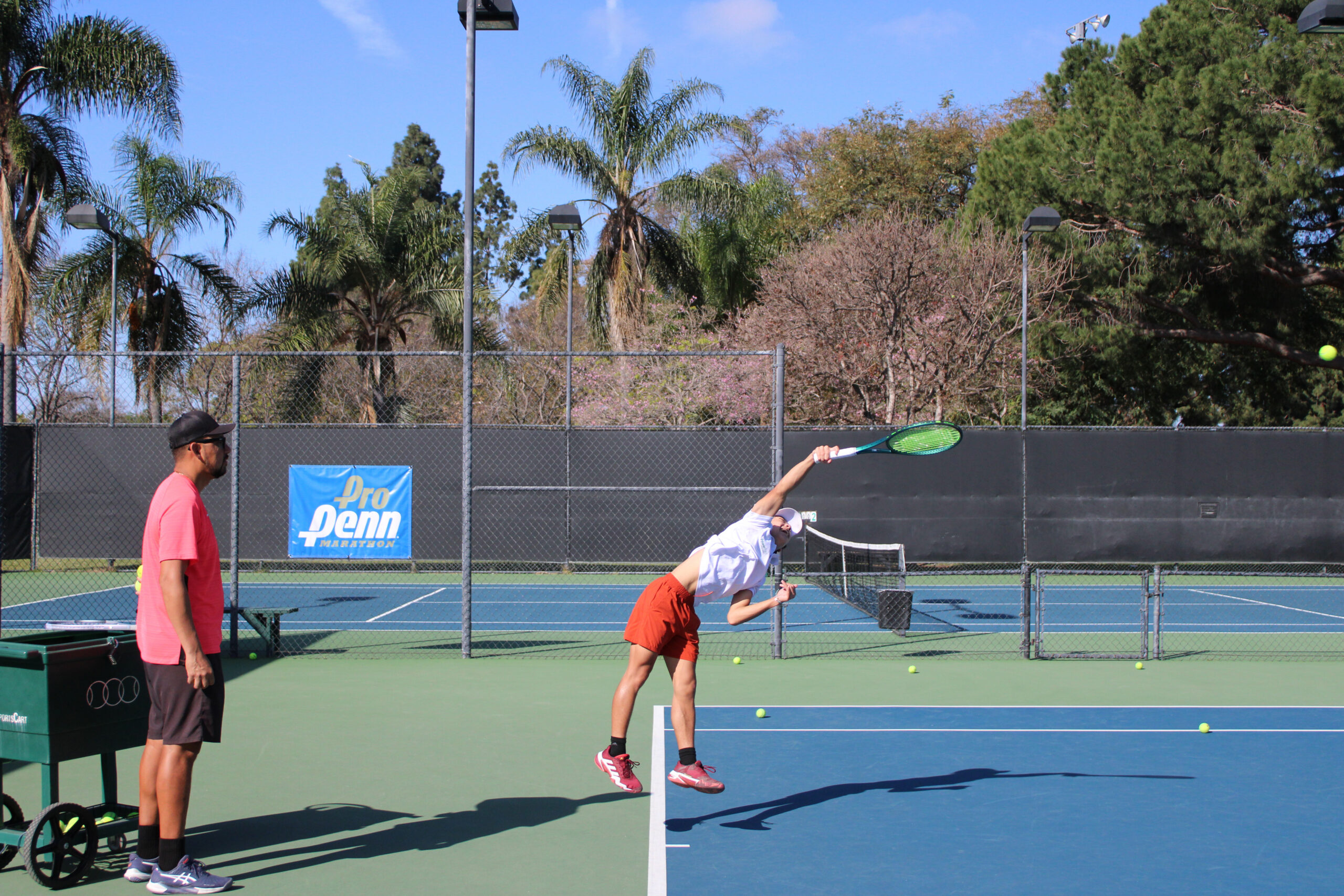 tennis- coach serving